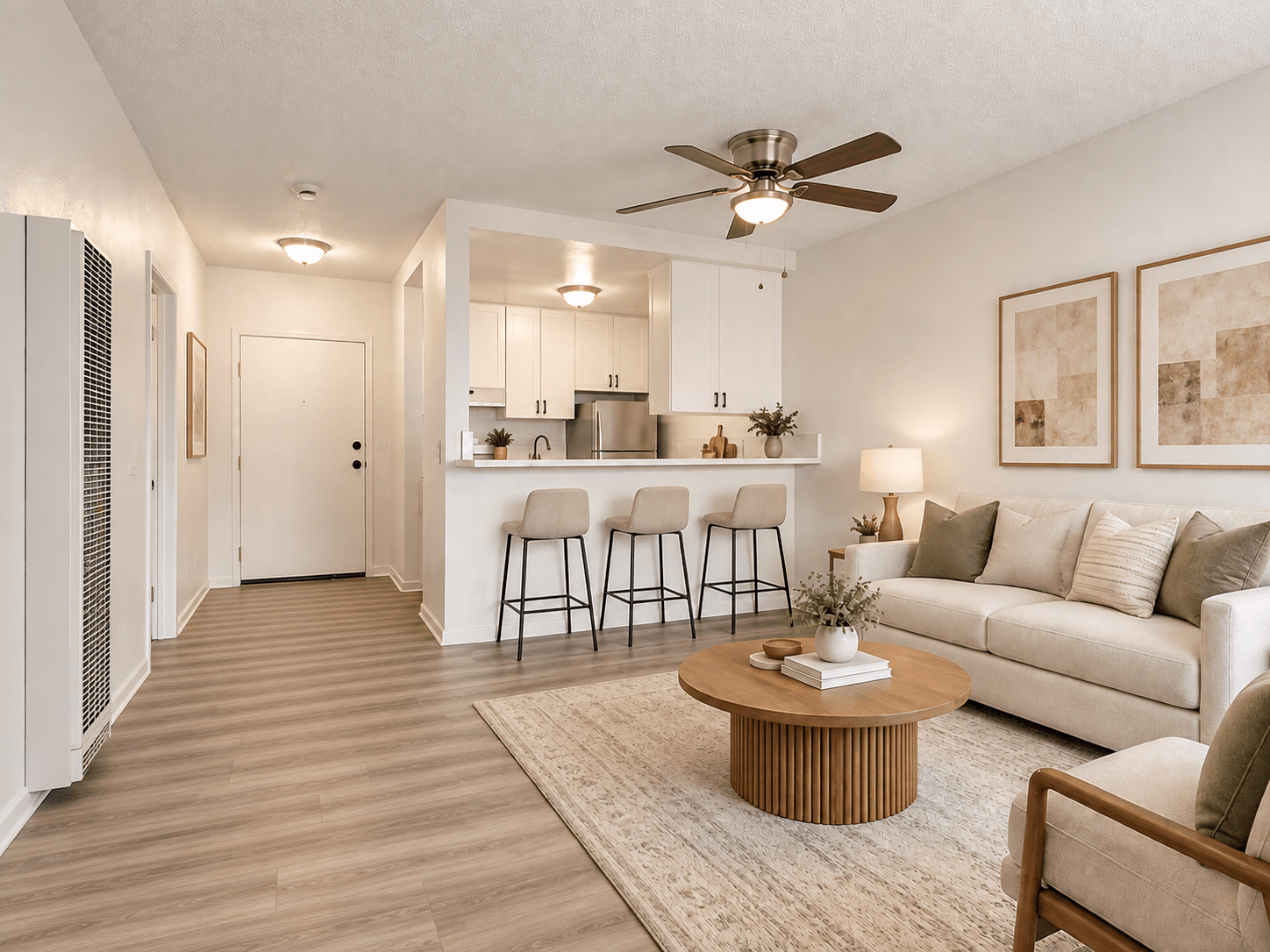 A living room with a white couch, a coffee table, and a ceiling fan.